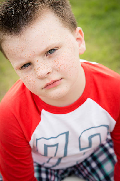 istock Little Boy with Freckles Sitting Outside 532007233