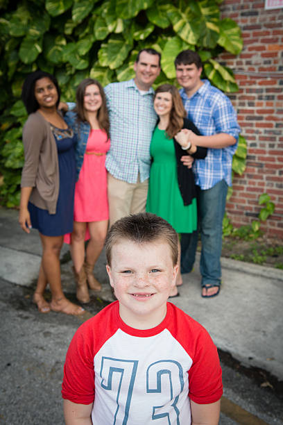 istock Happy Boy Smiling with Family in Background Outside 532007567