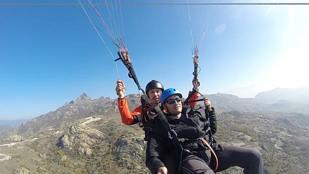 istock Tourist playing paragliding guided by a pilot 532008365