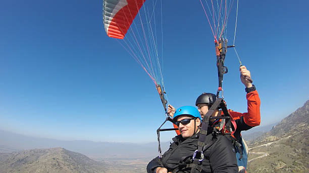 istock Tourist playing paragliding guided by a pilot 532008373
