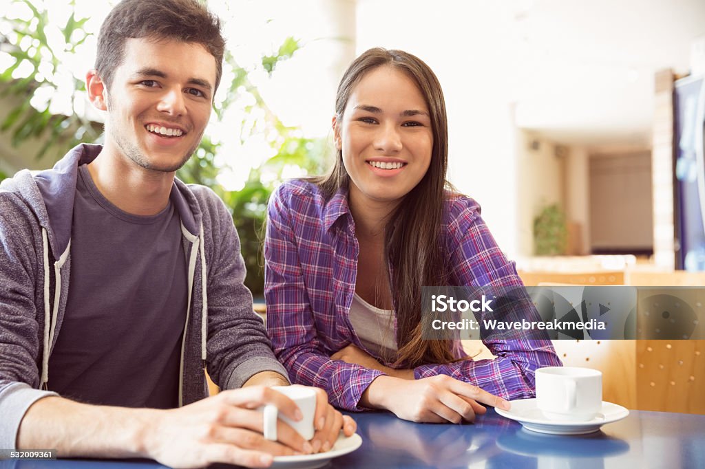 Young students smiling at camera in cafe Young students smiling at camera in cafe at the university 18-19 Years Stock Photo