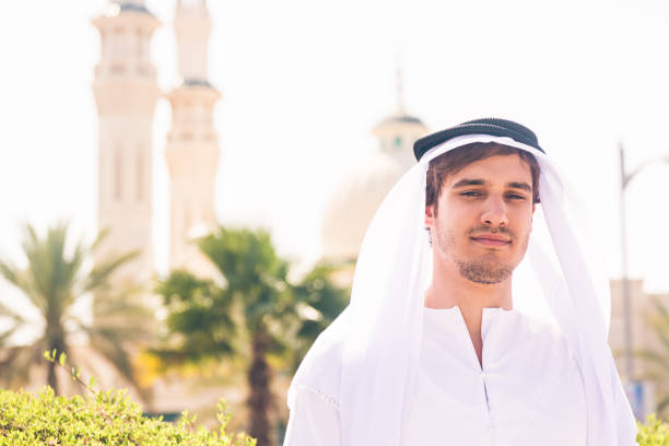 arabian man standing in front of mosque