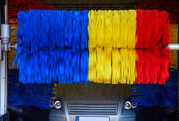 istock Wet car in car wash station with rotating brushes 532009675