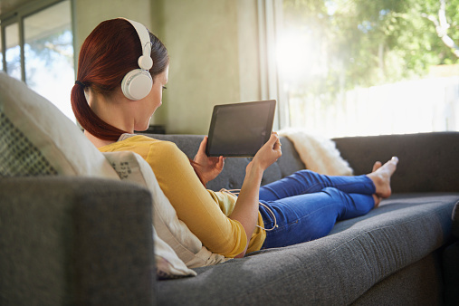 Cropped shot of an attractive young woman listening to music on her digital tablet