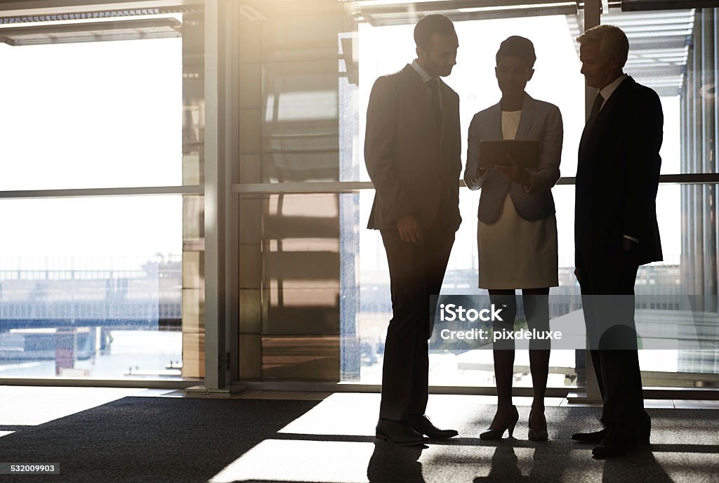 Look at this Shot of three businesspeople looking at a digital tablet together 2015 Stock Photo