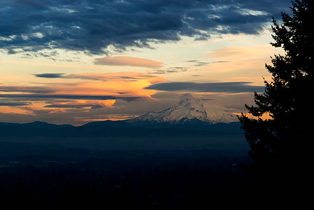 Lenticular clouds surround Mount Hood at sunset stock photo