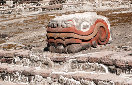 The Serpiente Emplumada (feathered serpent), dedicated to the god Quetzalcoatl, guarding the entrance to the ruins of the Aztec main temple, the Templo Mayor in downtown Mexico City. Before the Spanish conquest, Mexico City was the capital of the Aztec empire.