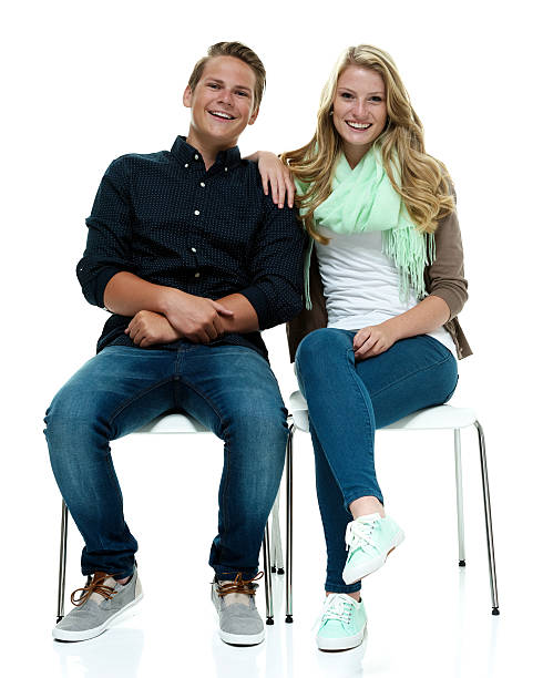 istock Smiling couple on chair & looking at camera 532018565
