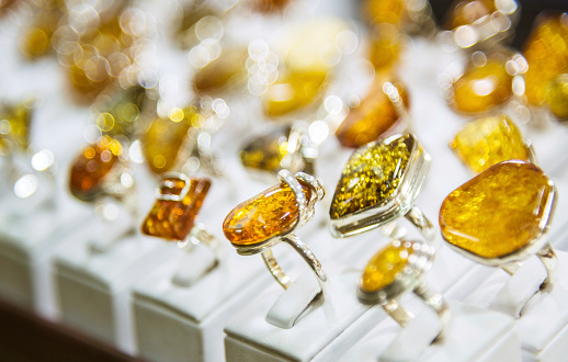 Variety of golden amber rings for sale at a store