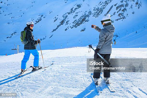 Photographing Snow Skier Skiing Couple Teens Boy And Girl Enjoying Stock Photo - Download Image Now