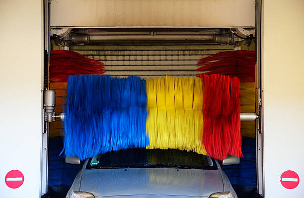 istock Wet car in car wash station with rotating brushes 532021487