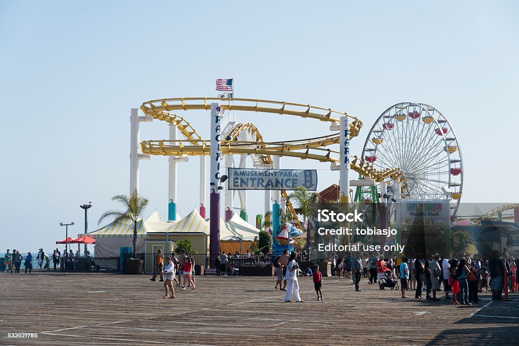 Santa Monica Pier Santa Monica, Los Angeles, California, USA - May 27, 2014: People having fun on the Santa Monica Pier during a sunny day. The Santa Monica Pier is a large pier located at the foot of Colorado Avenue in Santa Monica, California. 2015 Stock Photo