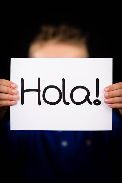 istock Child holding sign with Spanish word Hola - Hello 532022141