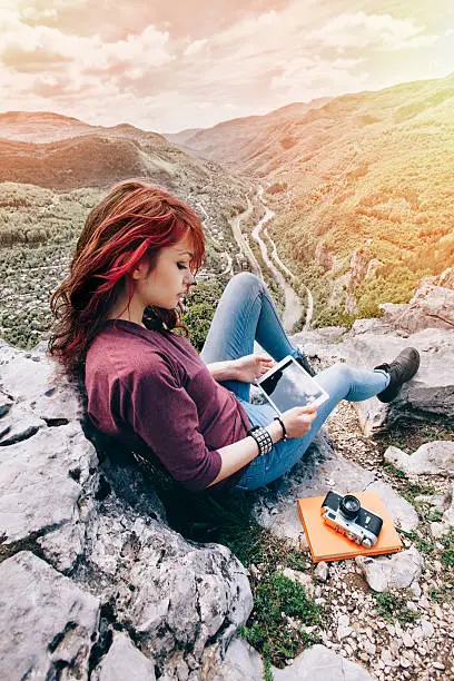 Photo of Girl using tablet pc among nature