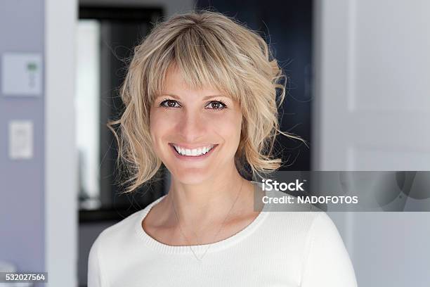 Portrait Of A Mature Woman Smiling At The Camera Stock Photo - Download Image Now - Short Hair, Mature Women, Women