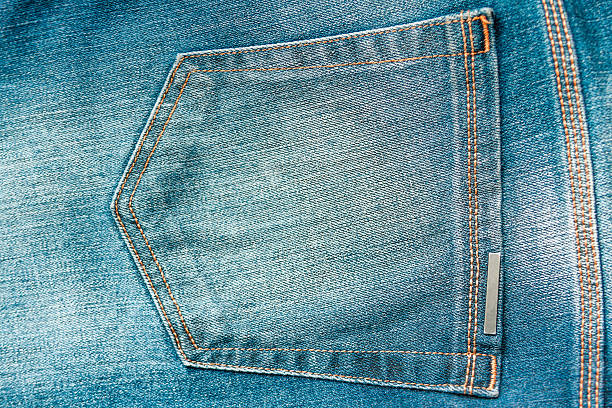 istock Back pocket of a blue jean with yellow stitching 532027636