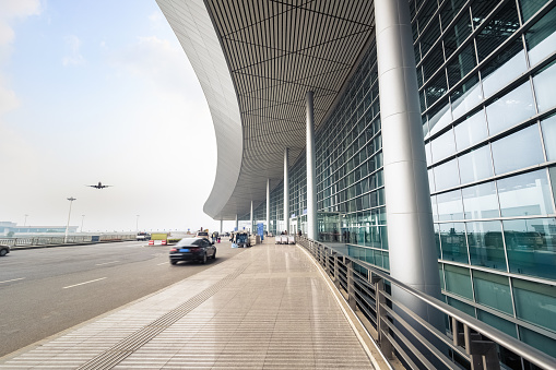 airport terminal outside,flight arrive and road with modern glass buildings