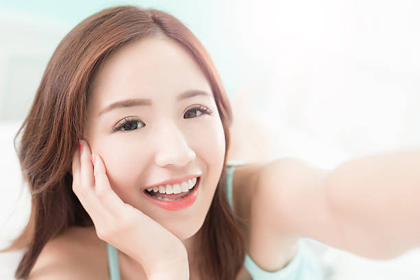 istock smile woman take a selfie 532031416