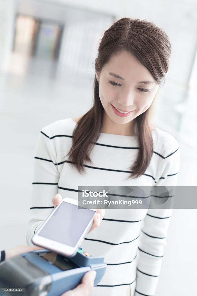 woman pay by smart phone young woman pay by smart phone with empty screen, great for your design,asian beauty Adult Stock Photo