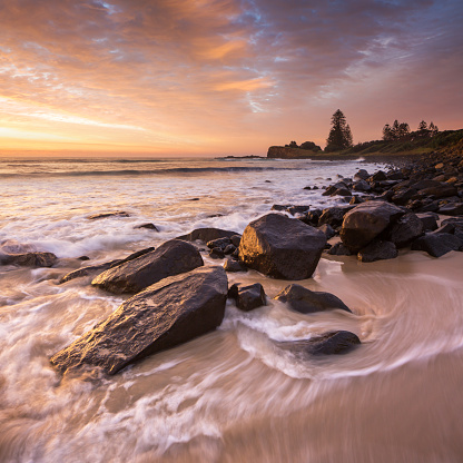 Waves wrapping around coastal rock formations at Boulder Beach, between Ballina and Lennox Head and Skennars Head.