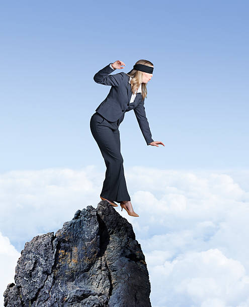 istock Blindfolded Businesswoman Balances On Mountain Top 532033148