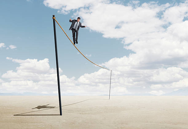 istock Businessman Precariously Walking A Tightrope 532035204