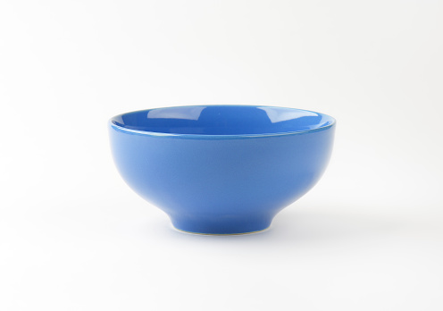 empty blue ceramic bowl on white background