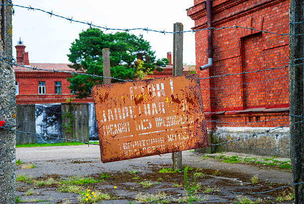 Sign board with warning on russian at prison entrance