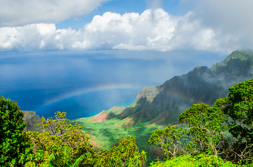 The green ridges of Kalalau Valley against the deep blue ocean on the Hawaiian Island of Kauai.