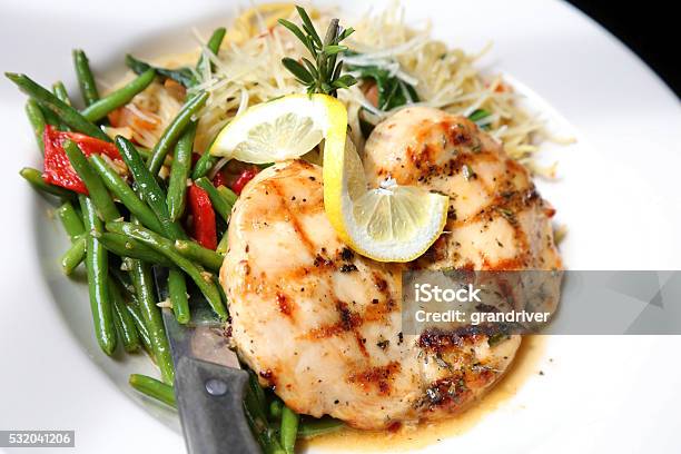Lemon Rosemary Chicken On Plate Of Spaghetti And Green Beans Stock Photo - Download Image Now