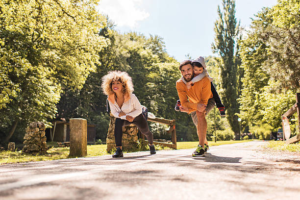 istock Young smiling family doing stretching exercises in nature. 532046554