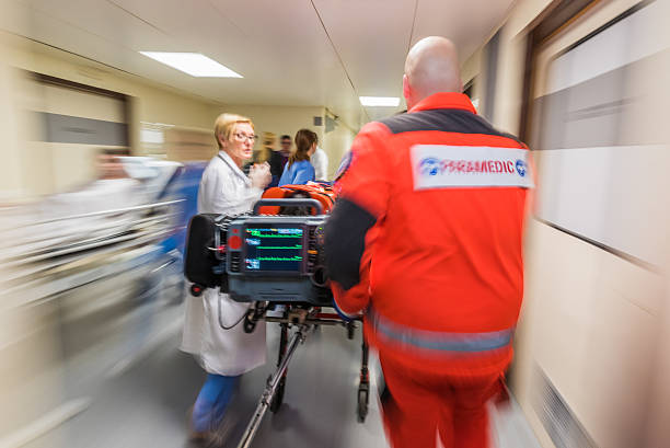 istock Paramedics wheeling patient in hospital 532047834