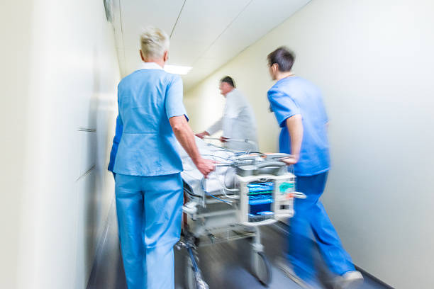 istock Hospital staff wheeling patient 532048052