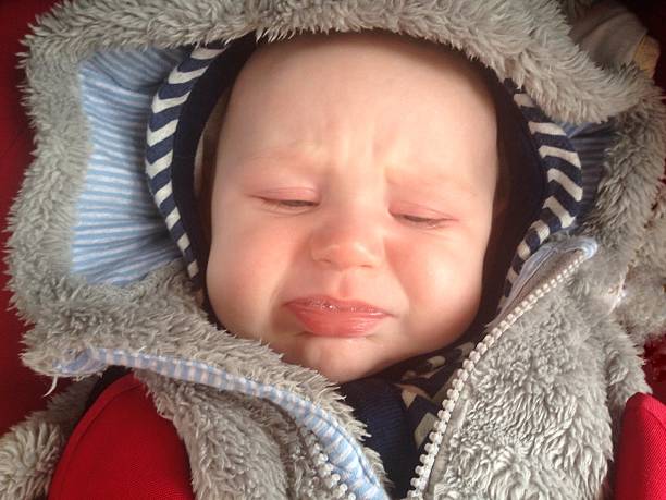 istock Crying baby boy in fluffy hood 532049622