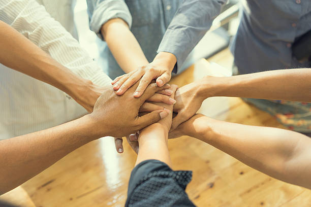 istock business people showing unity with their hands together 532049922