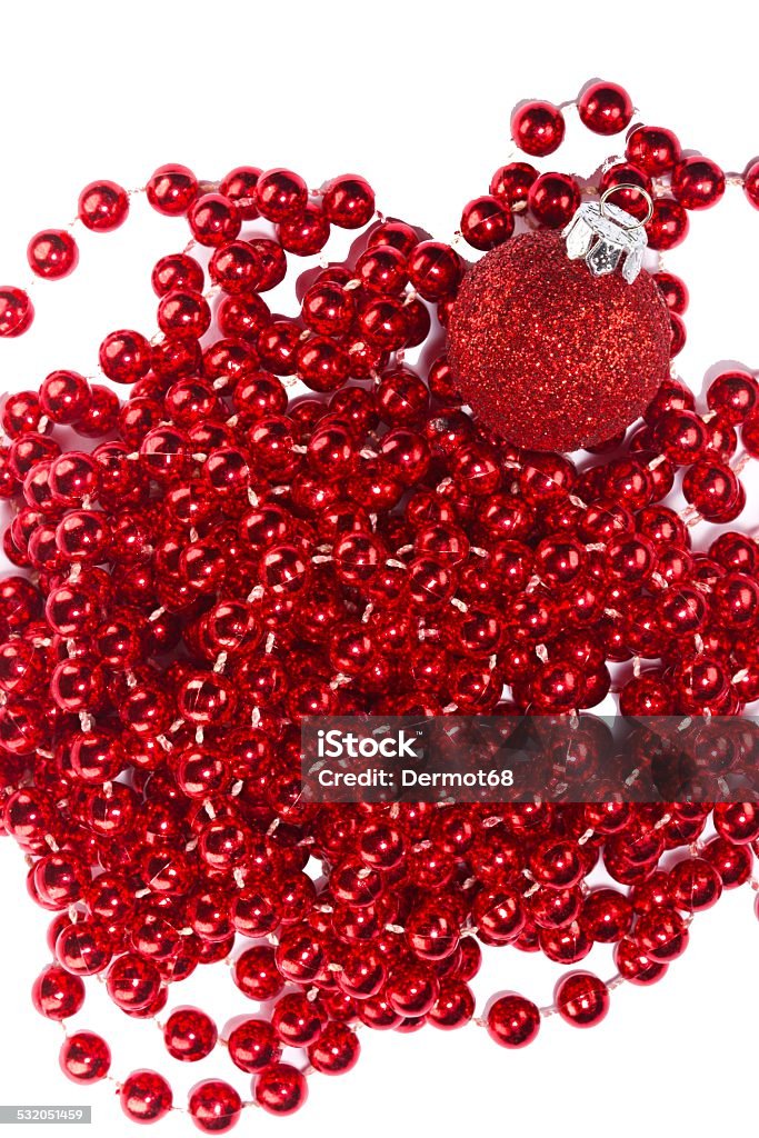 Red Christmas beads and ornament Photo shows a closeup of red Christmas beads and ornament on a white background. 2015 Stock Photo