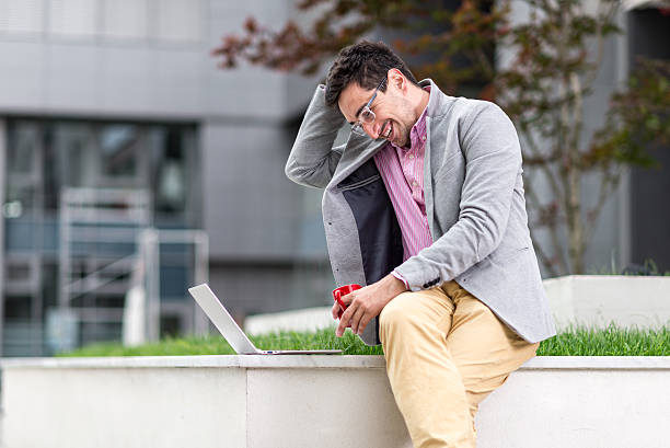 istock Young businessman using laptop outdoors 532054254