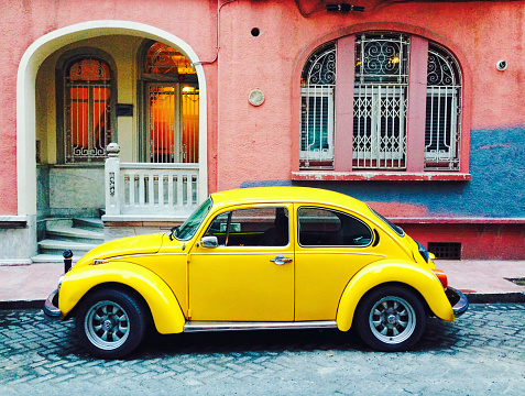 Istanbul, Turkey - January 13, 2015: Old yellow Volkswagen Beetle car parked on in the street. The Volkswagen Beetle was an economy car produced by the German auto maker Volkswagen from 1938 until 2003.