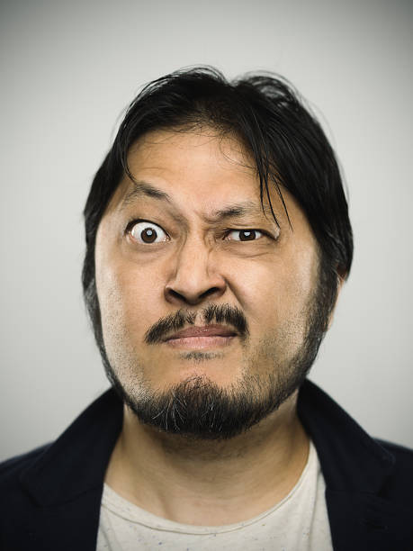 Portrait of a young japanese man with angry expression
