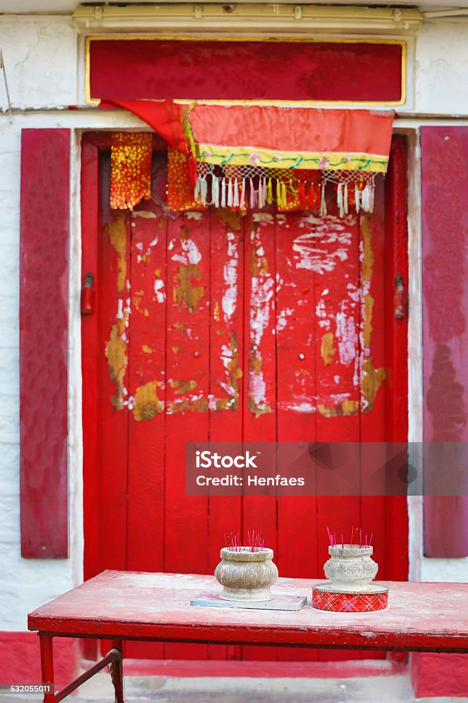 Incense burners alongside a Buddhist temple Incense burners alongside a temple - one sat on an old biscuit tin 2015 Stock Photo