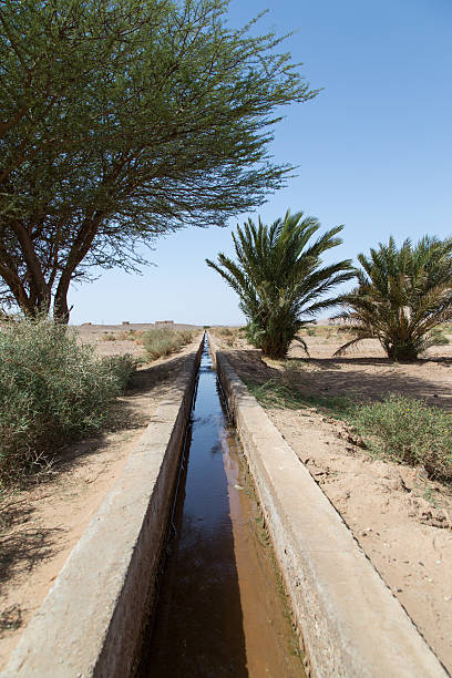 Water supply channel in the desert in Morocco. stock photo