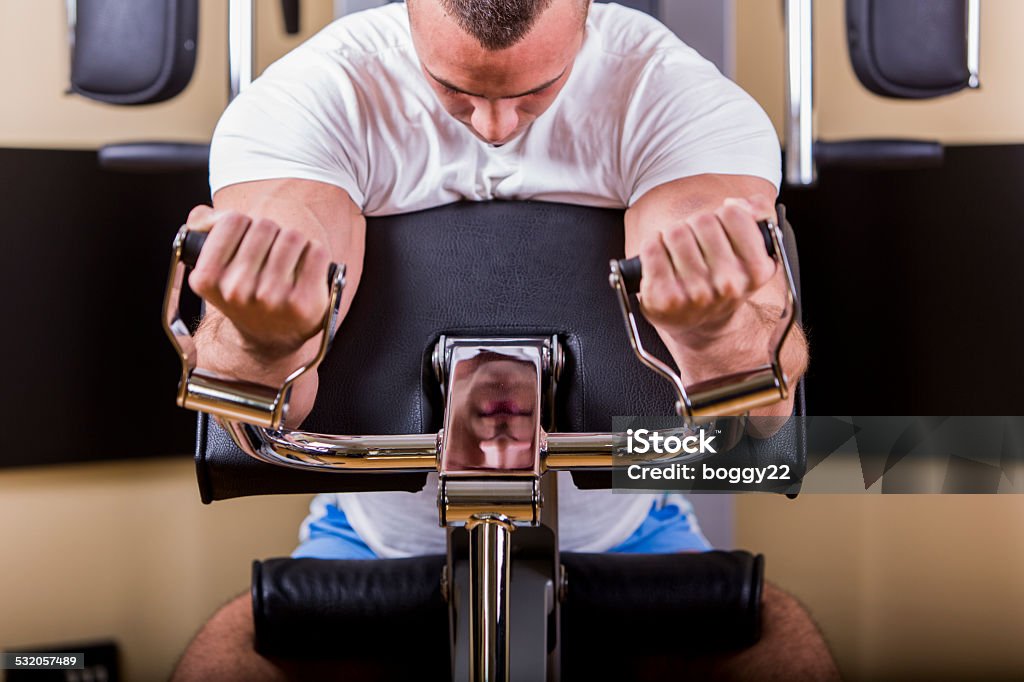 Young man training in the gym Attractive young man training in the gym 2015 Stock Photo