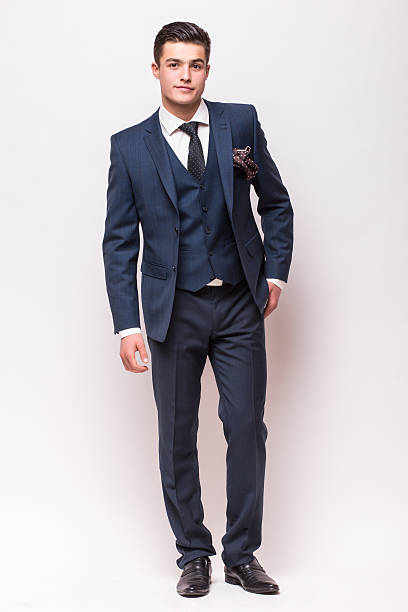 istock Handsome young businessman  in suit standing against white background 532059442