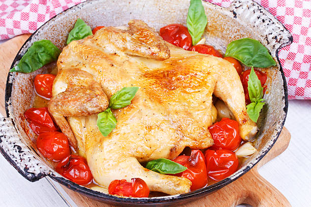 Roast chicken with tomatoes cherry, green basil and garlic