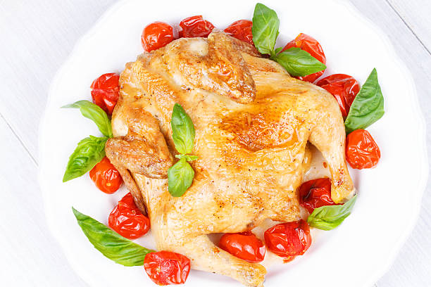 Roast chicken with tomatoes cherry, green basil and garlic