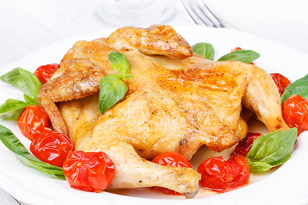 Roast chicken with tomatoes cherry, green basil and garlic