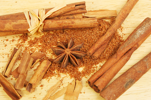 Cinnamon, star anise and Chinese five spice on a wooden board