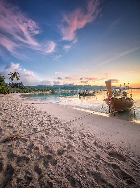 istock sunset with colorful sky and boat on the beach 532089771