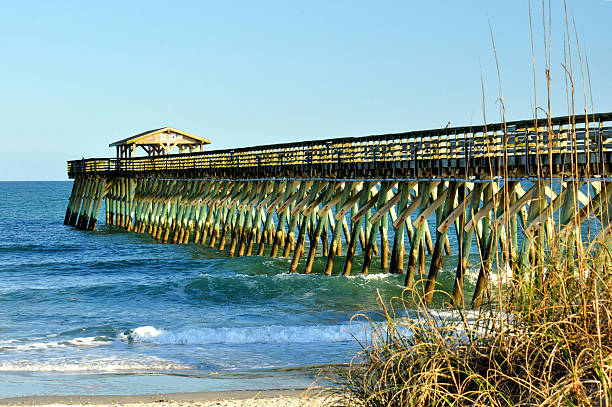 istock Fishing pier reaching out into ocean. 532091221
