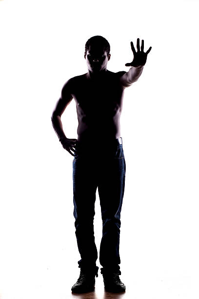 istock Silhouette of African man on a white, showing stop hand 532091619